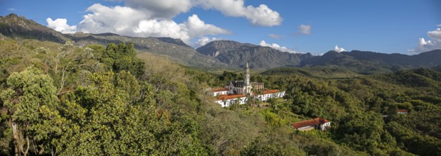 Aerial view panorama of Sanctuary Caraca with shadows, mountains, blue sky in background, Minas