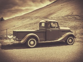Retro Style Sepia Image Of A Vintage Truck In The Countryside