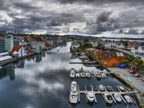 Boats in the harbour, dark clouds in the sky, reflections in the water, atmospheric, Haugesund,