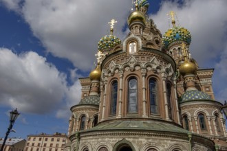 Russian church with magnificent onion domes and richly decorated façades in the sunlight against a