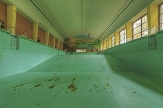 Abandoned, empty swimming pool with rust stains and wall painting, Bad am Südpark, Essen-Kray,