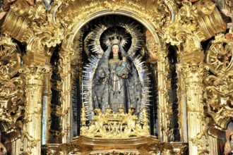 Detail of a Baroque altar with a gilded statue of the Madonna and Child Jesus, Iglesia de Santa