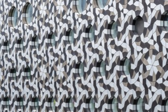 Facade with geometric patterns and circular windows creating a modern architectural design, London,
