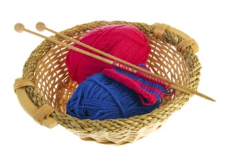 Knitting in blue and red with wooden needles