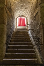 Old corridor with red curtain at the end. Concept for mystery, gothic, escape, hope