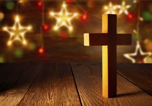 Christian wood cross on Christmas stars wooden background