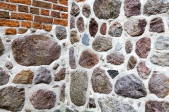 Old stone wall made of erratics rocks and bricks, Church of St. Urbanus, Dorum, Lower Saxony,
