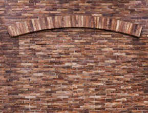 Texture of old red brick wall with an arch, grungy background