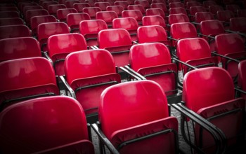 Empty plastic red chairs In outdoor theater in sunny day. Close Up