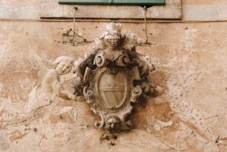 A bas-relief on the facade of a building in the old town of Kotor in Montenegro. Knight's shield
