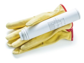 Working gloves and roll of blueprit isolaed on white