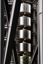 Close-up of an industrial-style building featuring metal structures and vertical elements, London,