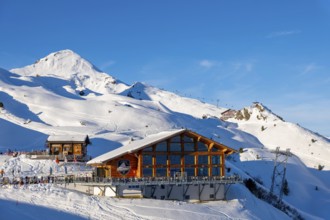 Ski Slope with Overhead Cable Car and Restaurant at 2000 Meters High Up and Mountain Peak in a
