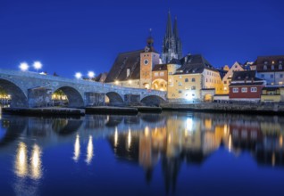 Regensburg cityscape during blue hour with light reflections in the river Danube