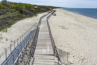 Wooden decking on the sea. Promenade on the sea beach. Deserted sea pier. Walking pier on the beach