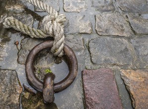 Close up image with a solid iron ring used to secure the anchoring of the ships on the docks,