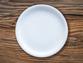 An Empty White Plate On A Rustic Wooden Table