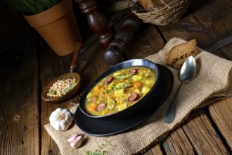 Rustic pea soup with bacon and sausage