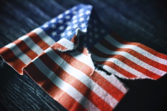 Torn US flag, symbolic photo for a divided society in the USA