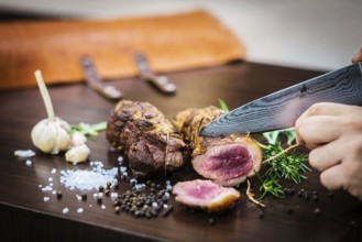 Serving carving roast pork meat roll meal in rustic style with seasonings