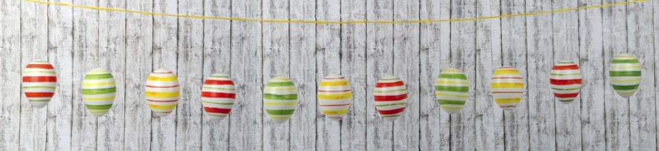 Colourful Easter eggs on a string in a row