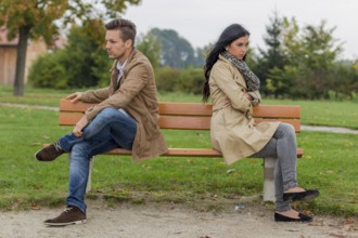 A young couple sits on a park bench and argues Austria