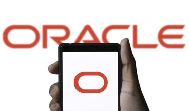 ORACLE logo displayed on smartphone screen. ORACLE is a multinational computer technology