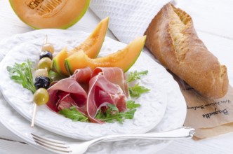 Ham with melon and olives