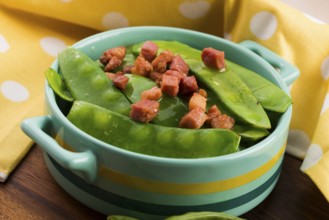 Fresh green peas with bacon