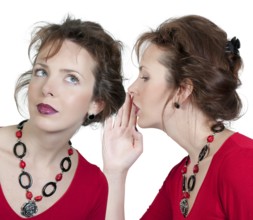 A young beautiful woman whispering a secret