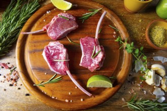 Raw fresh lamb chops Wooden chopping board