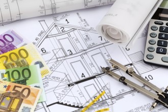 An architect's construction plan with a pocket calculator and euro money. Symbolic photo for