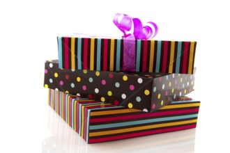 Stacked gifts striped and dotted isolated over white