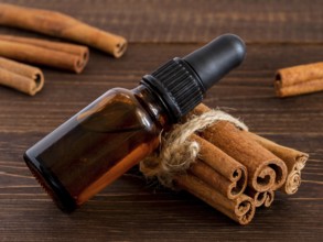 Cinnamon sticks and bottle with cinnamon essential oil