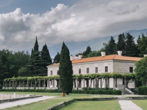 Villa Milocer with a pergola covered with green ivy and a luxurious garden.