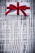 Copyspace of packed giftbox on vintage wood board holidays concept