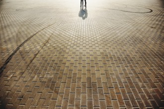 Lovely couple on the square with stone floor background.