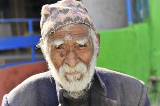 An aged man with a cap shows a striking face full of character, Pokhara Valley, Pokhara, Nepal,