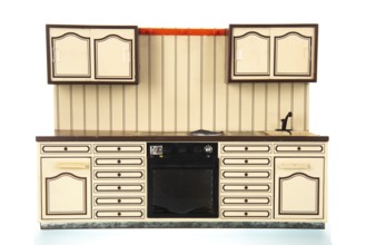 Miniature vintage toy kitchen isolated over white background
