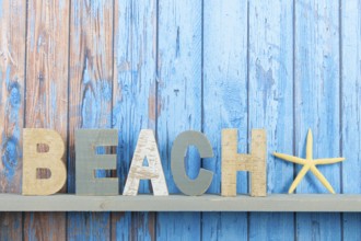 Blue wooden background with vintage beach text