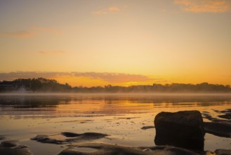 Sunrise over the Weser with stones and fog in the foreground, Julius Plate ferry pier 27804 Berne