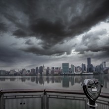 Manhattan New York cloudy dramatic skyline sunset from East River dusk USA