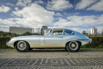 Lisbon, Portugal, Jan 20, 2024: Full side view of classic silver E-Type Jaguar Series 3 coupe car