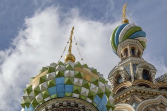 Top view of a church with colourfully decorated domes and golden spires under a cloudy sky, Saint