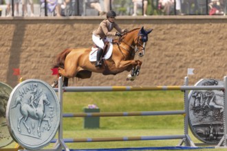 Elena A. Haas, from the United States and riding Claude, compete in the 1.60m Grand Prix during The
