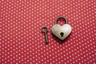 Heart shaped lock and key on an abstract background