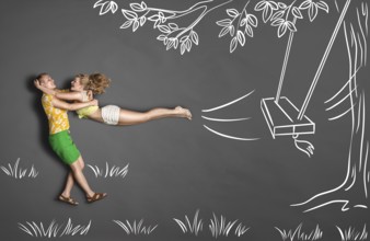 Happy Valentine's Day love story concept of a romantic couple against chalk drawings background.