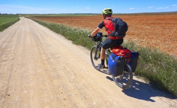 Biker pilgrim by Camino de Santiago in bicycle at Saint James Way of Levante