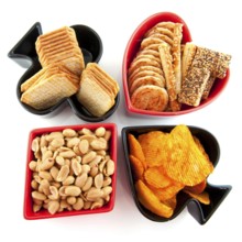 Playing card symbols as hearts clubs daimonds and spades with salted snacks
