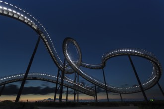 Roller coaster with illuminated design against the evening sky, Tiger and Turtle, Duisburg, North